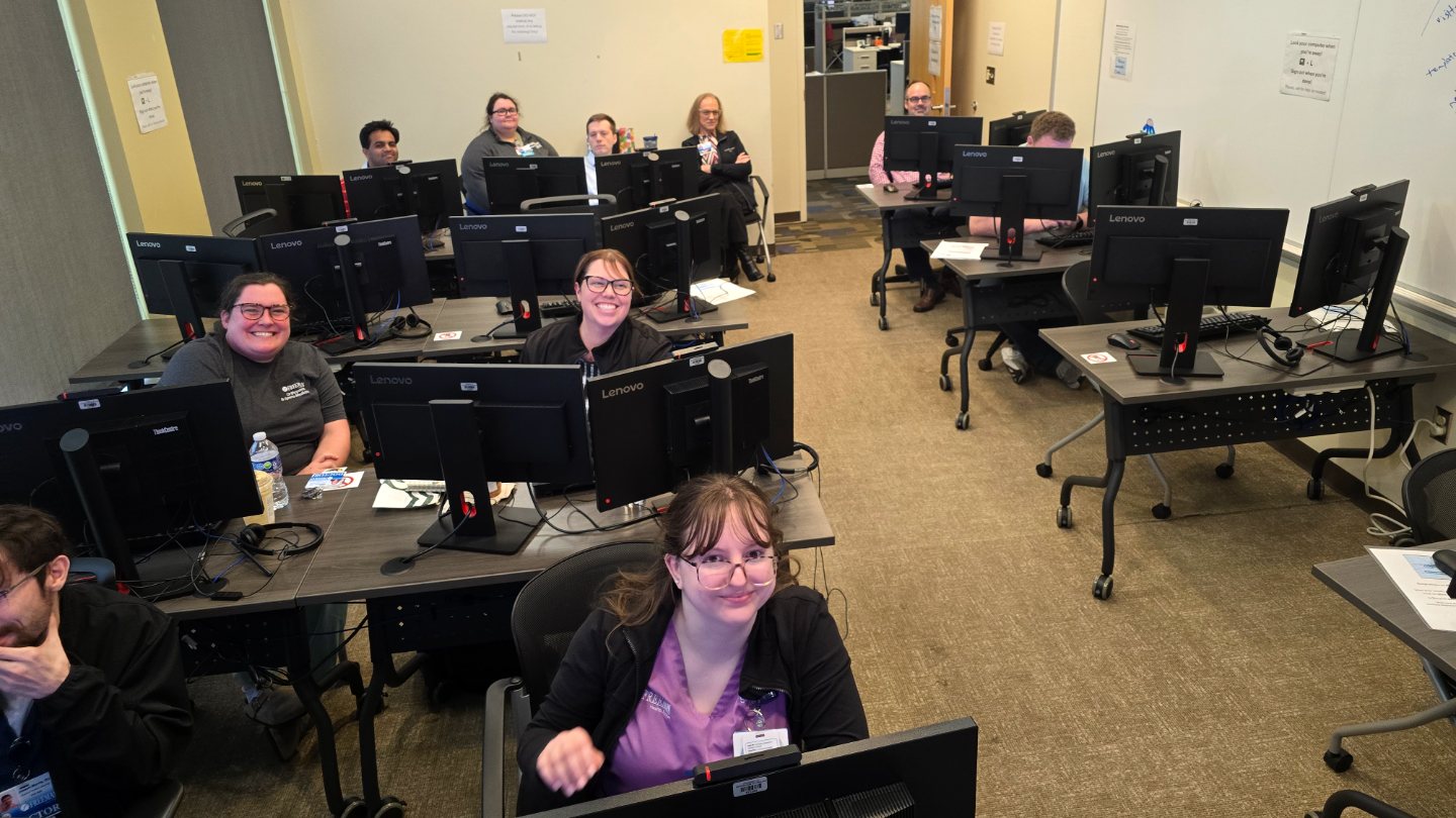 Freeman providers smiling at their workstations during an Epic training class