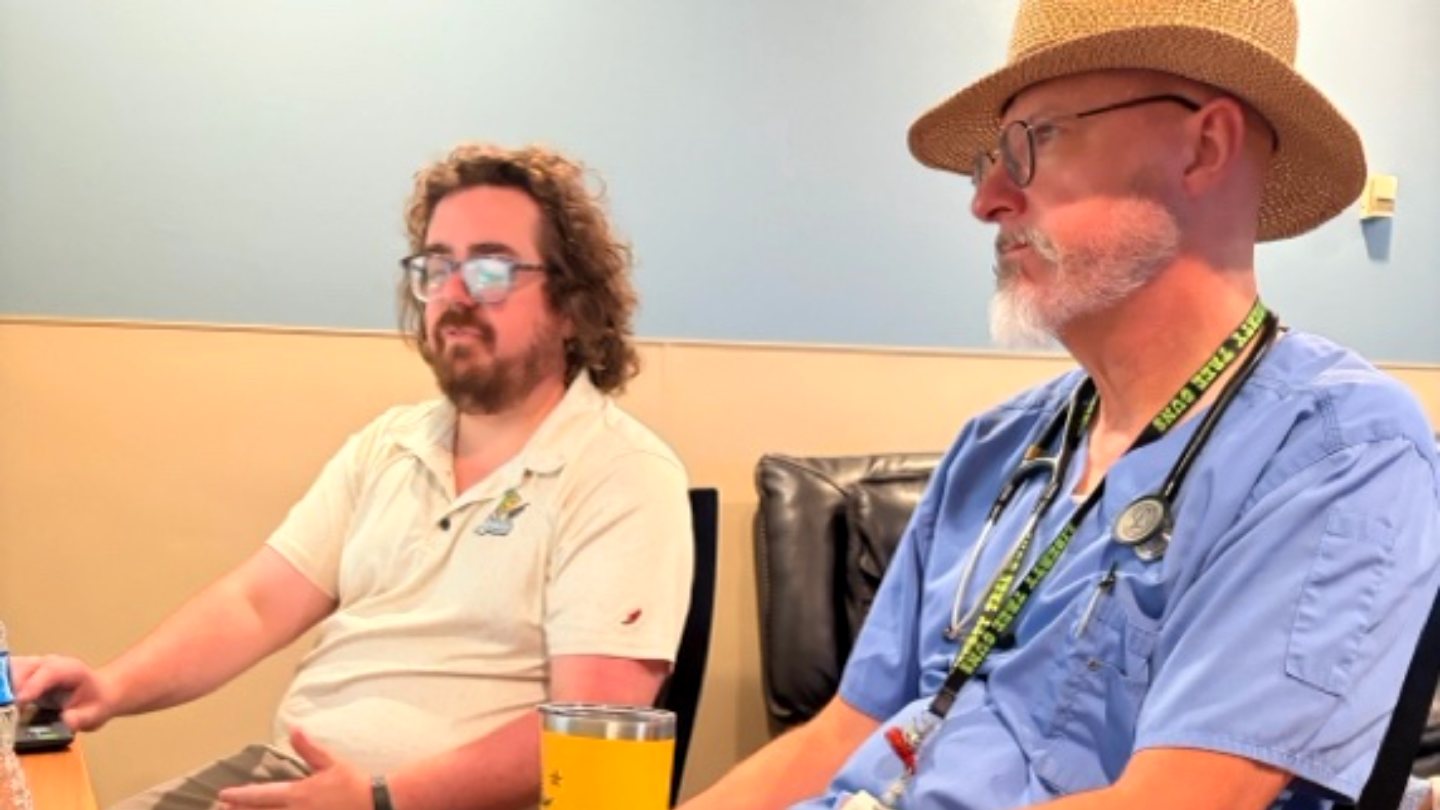 A Freeman physician and an Epic trainer talking at an August Lunch and Learn